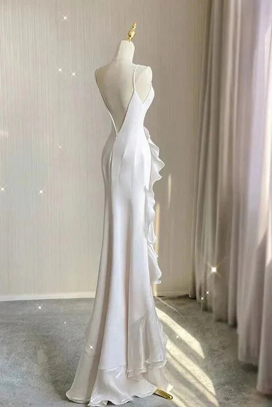 Side view of the white sheath halter wedding dress, showcasing its silhouette.