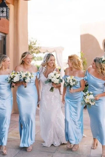 Full view of the elegant blue off-shoulder sheath dress with a satin bow.