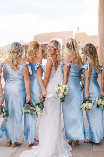 Back view of the blue off-shoulder gown with a satin bow detail.