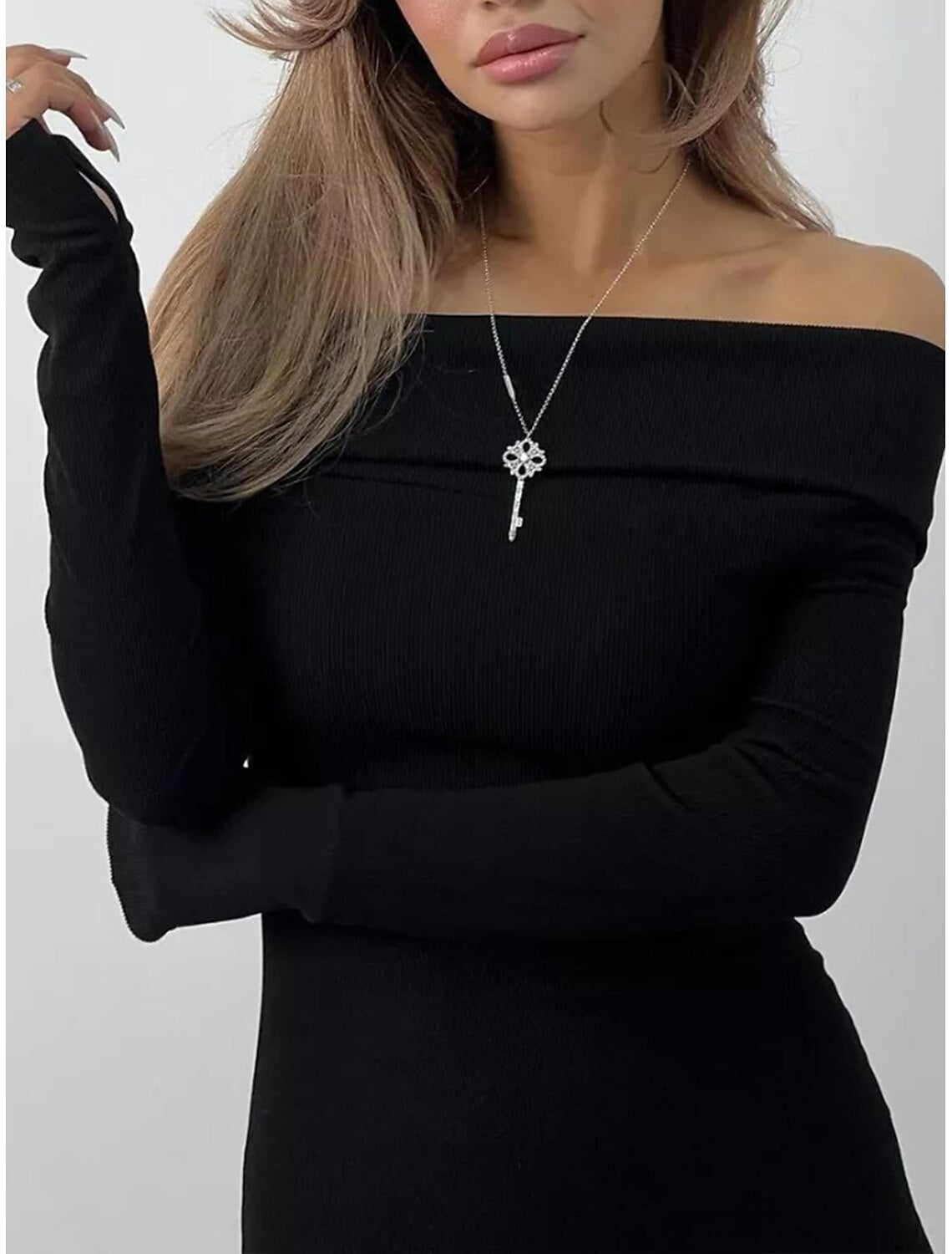 Back view of a woman showcasing the midi length of the sheath dress.