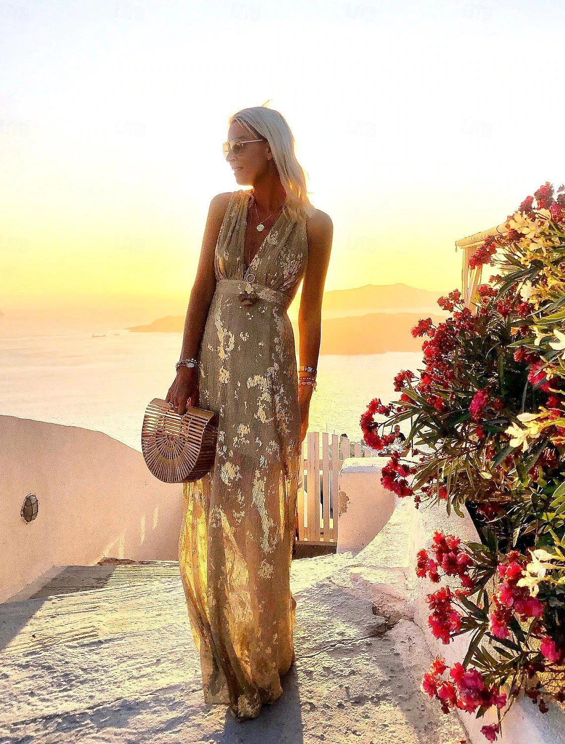 Full view of a woman in a shimmering A-line deep V vacation dress.