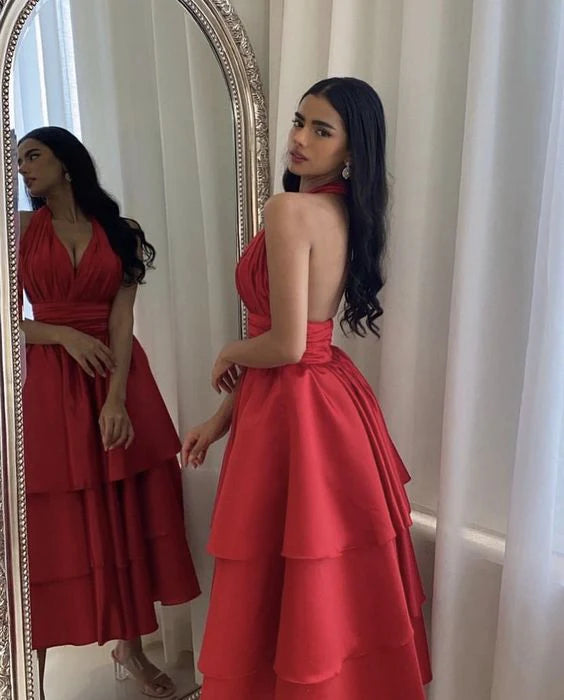 Full-length view of a woman wearing the short satin halter evening dress.