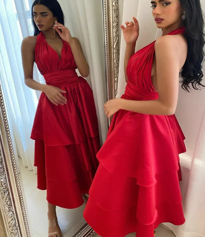 Back view of the elegant short satin halter dress, showing the open back design.
