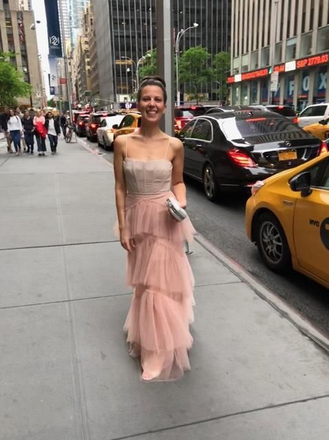 Woman wearing an elegant light pink long party dress.