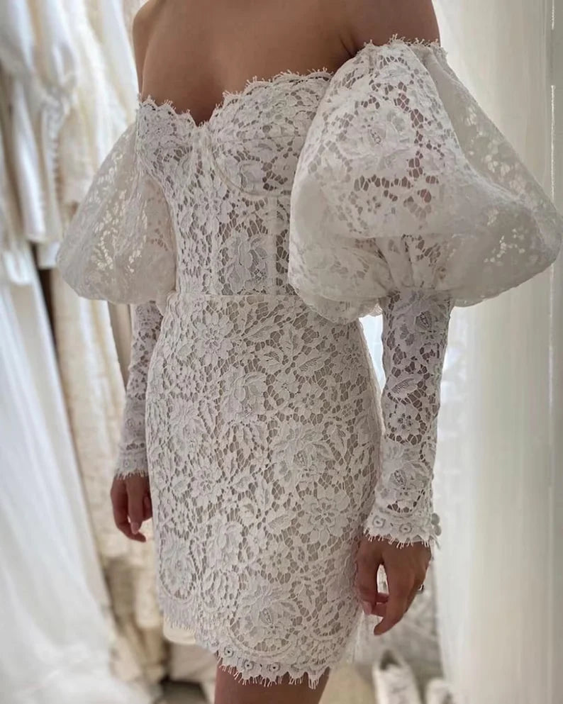 Woman wearing an elegant strapless off-shoulder long-sleeved lace slim fit ball gown.