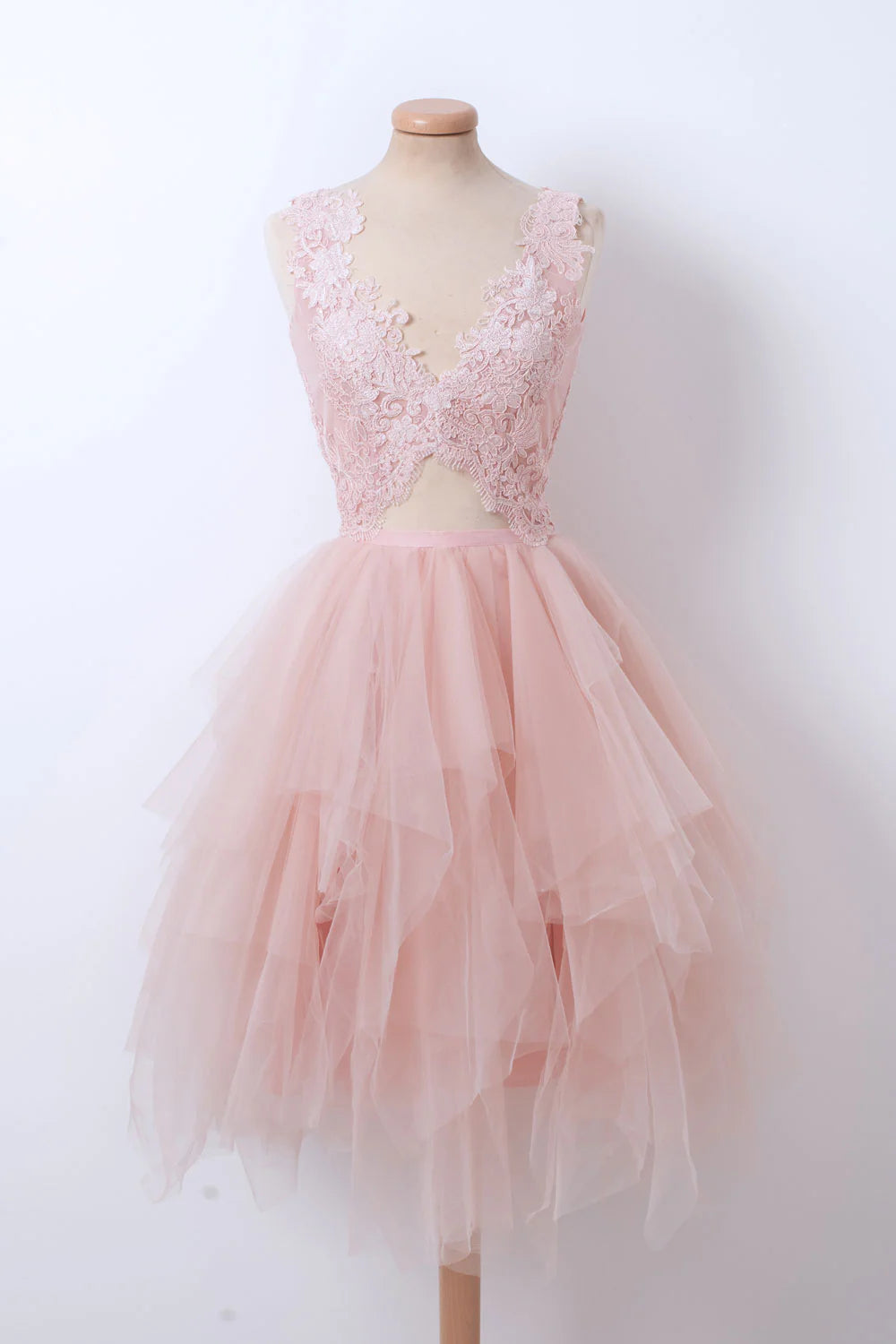 Front view of a woman wearing a pink V-neck tulle lace short prom dress.