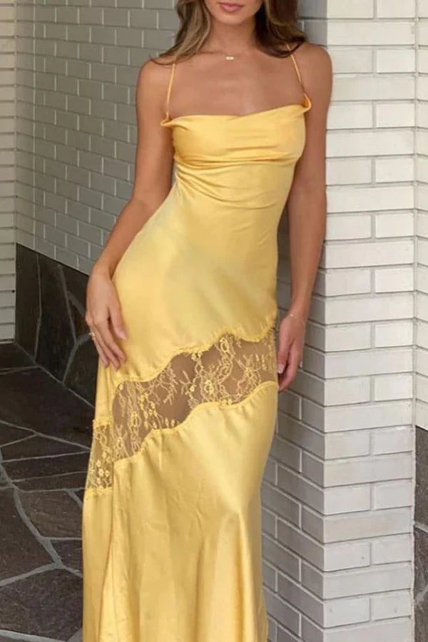 Front view of a woman wearing a long yellow slim-fit backless spaghetti strap prom dress.