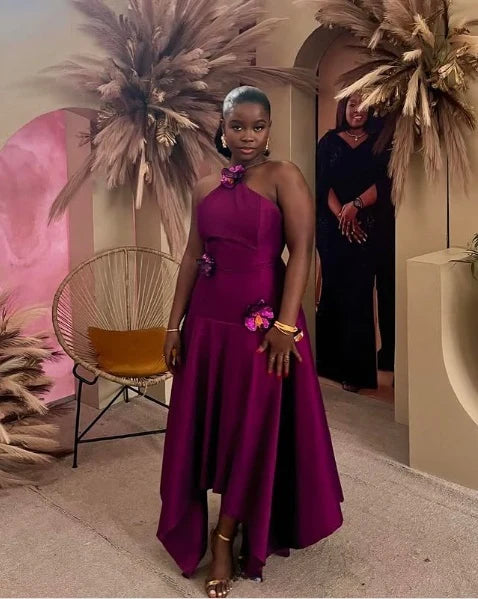 Close-up of the applique and halter neckline on the purple satin dress.