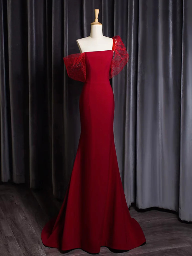 Front view of a model wearing a burgundy one-shoulder mermaid prom dress.