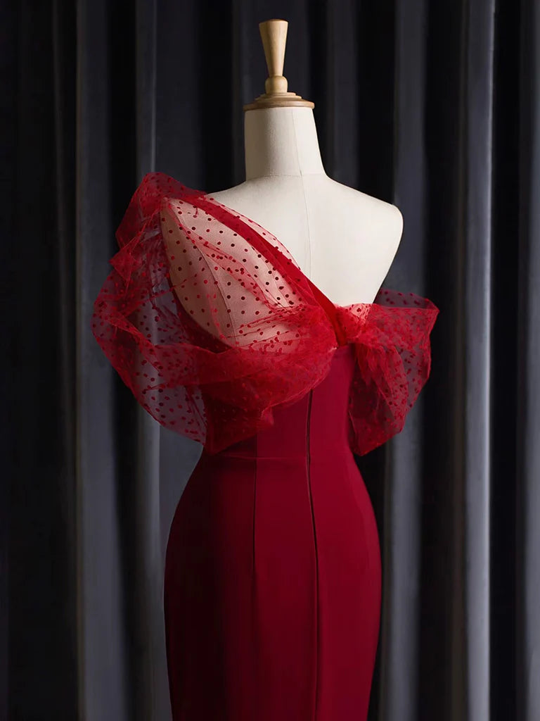 Side view of a model in a burgundy one-shoulder mermaid dress, showcasing the slim fit.