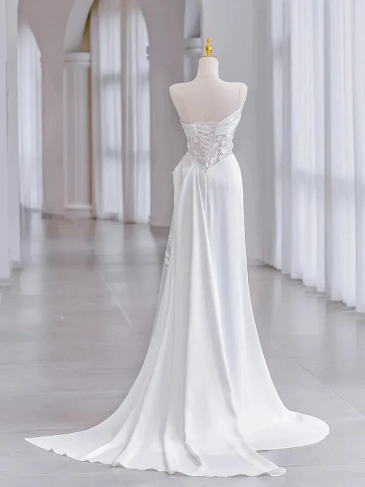 Side view of a slim-fit bridal gown with a cinched waist.