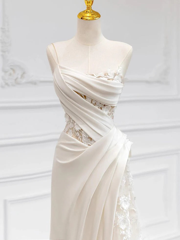 Back view of a long white wedding dress with a delicate lace train.