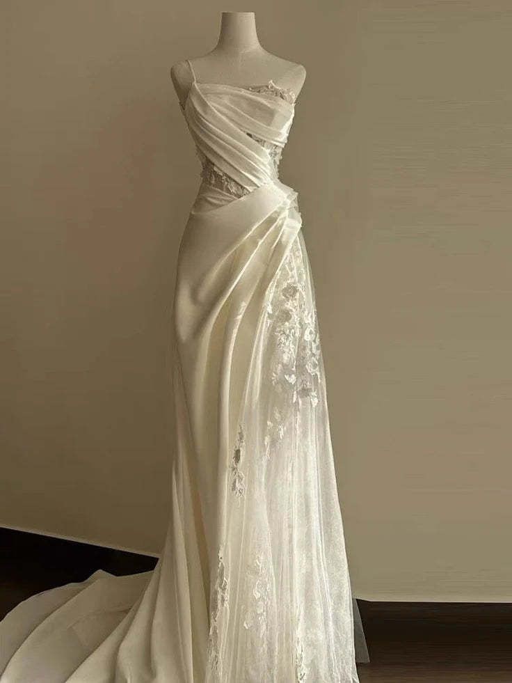 Close-up of the one-shoulder neckline and intricate lace fabric.