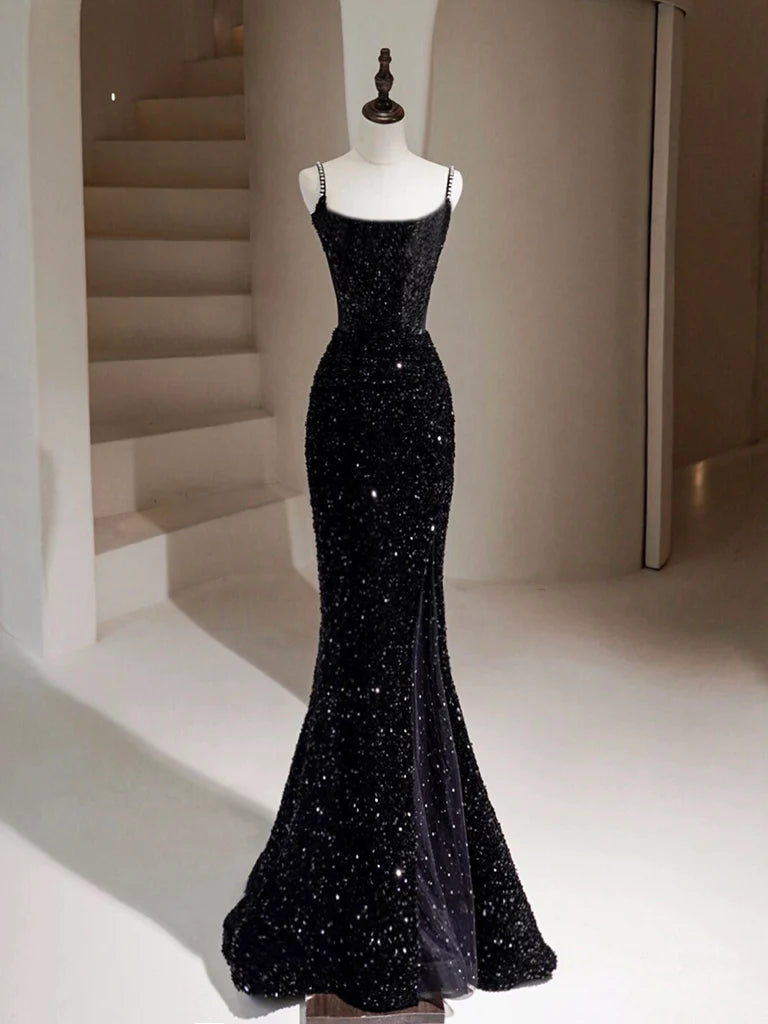Woman wearing a black sequin mermaid long prom dress, front view.
