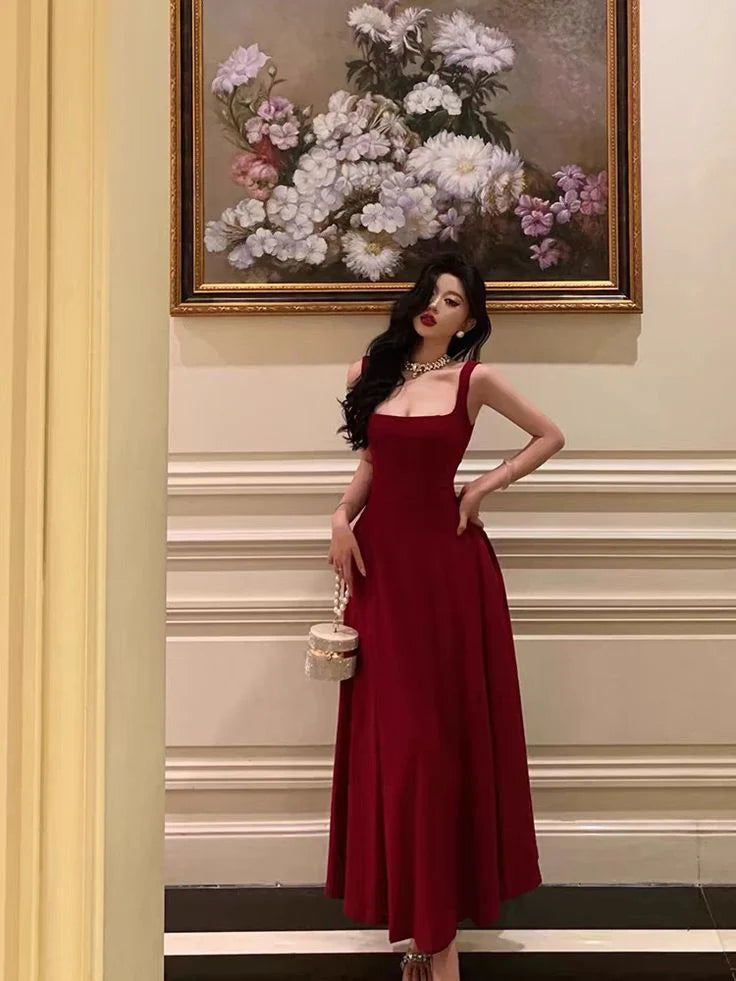 Model wearing an elegant burgundy slim-fit A-line prom gown with a square neckline.