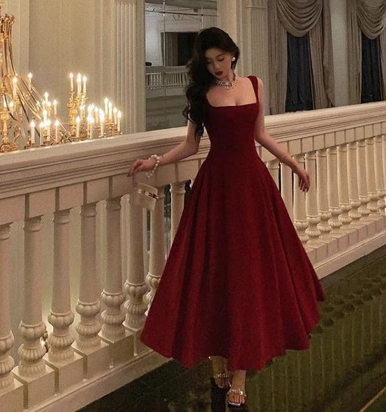 Close-up of the square neckline and slim-fit bodice of the burgundy prom gown.