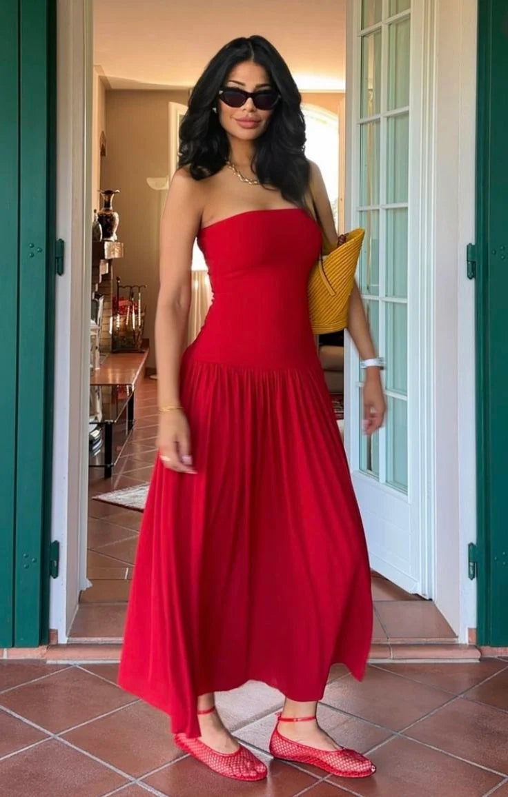 Woman wearing an elegant slim-fit red strapless A-line long dress.