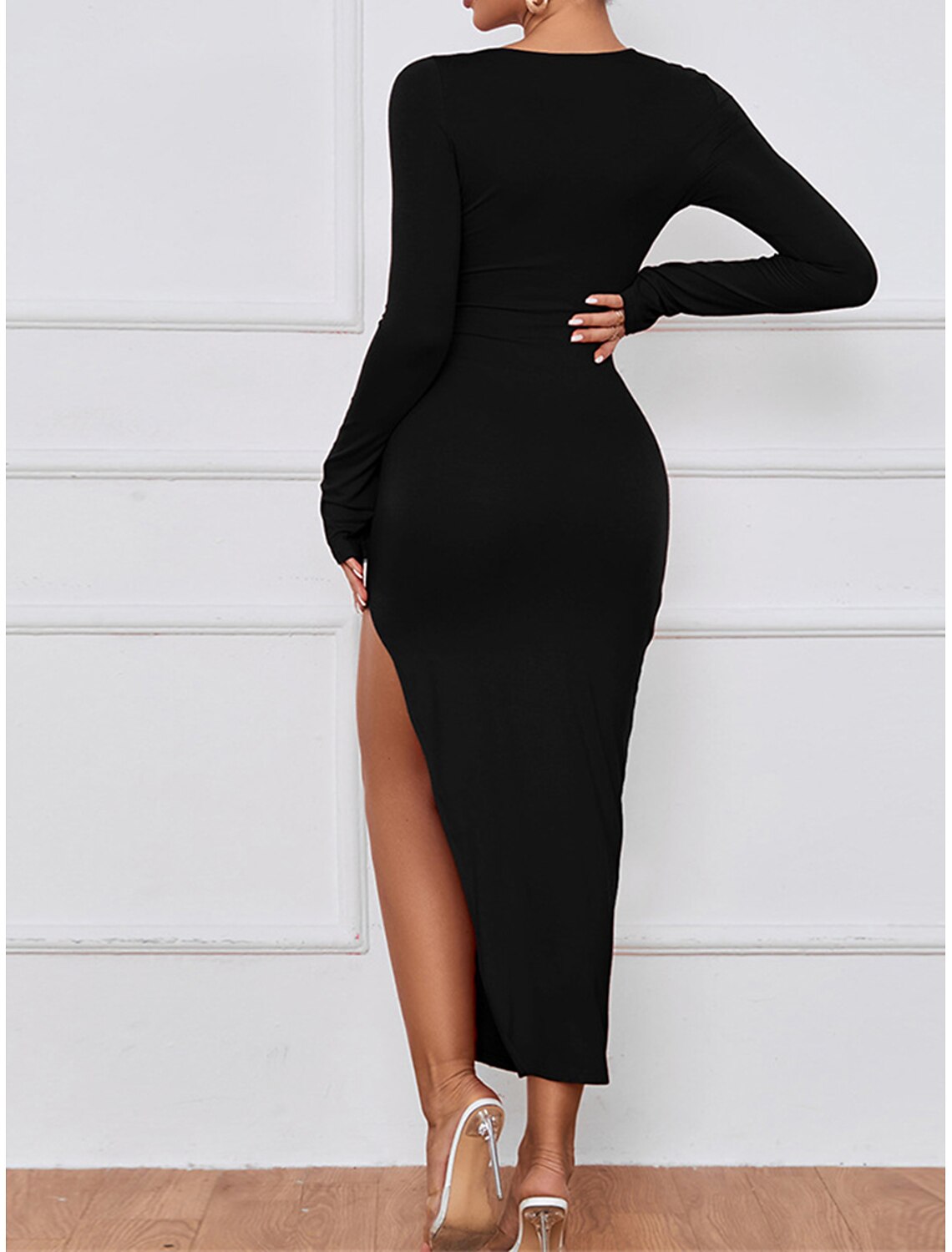 Back view of a woman in a black slim-fit V-neck long sleeve midi dress, showcasing the elegant silhouette.