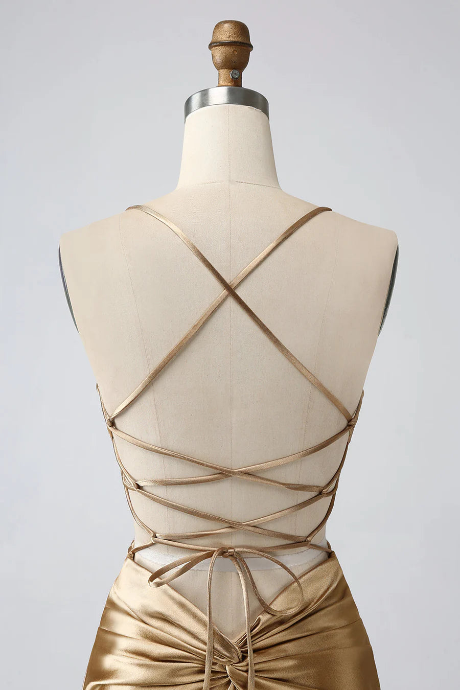 Model wearing a gold slim-fit V-neck twist-back satin short homecoming dress, side view.