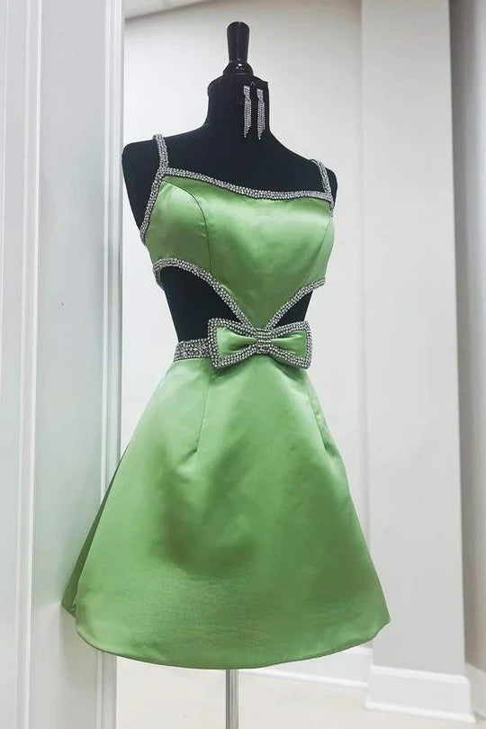 Close-up of the blue dress's playful cutout and charming bow accent.