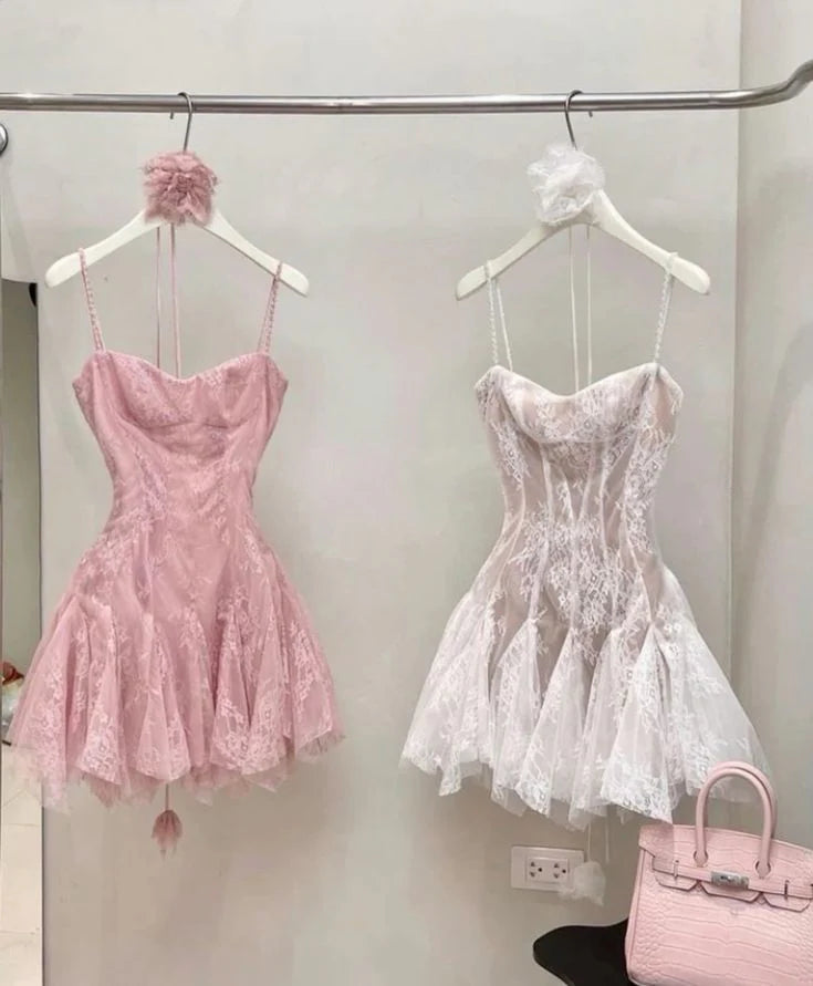 Woman wearing an elegant spaghetti strap mini lace cocktail dress, side view.