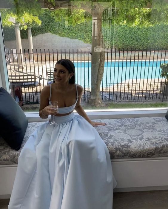Close-up of the bodice and skirt of a light blue formal two-piece evening gown.