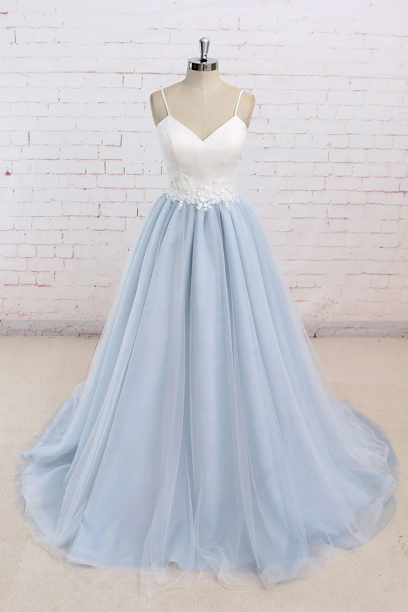 Model wearing an elegant strapless blue A-line tulle long prom dress with a cinched waist.