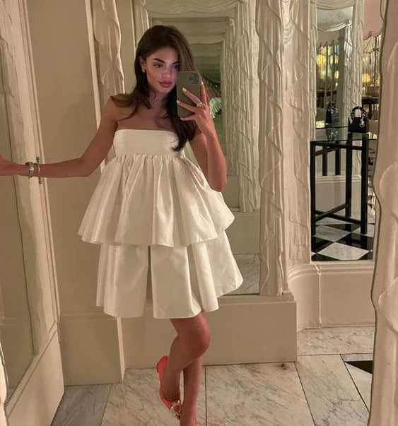 Elegant strapless A-line short satin dress in blush color.