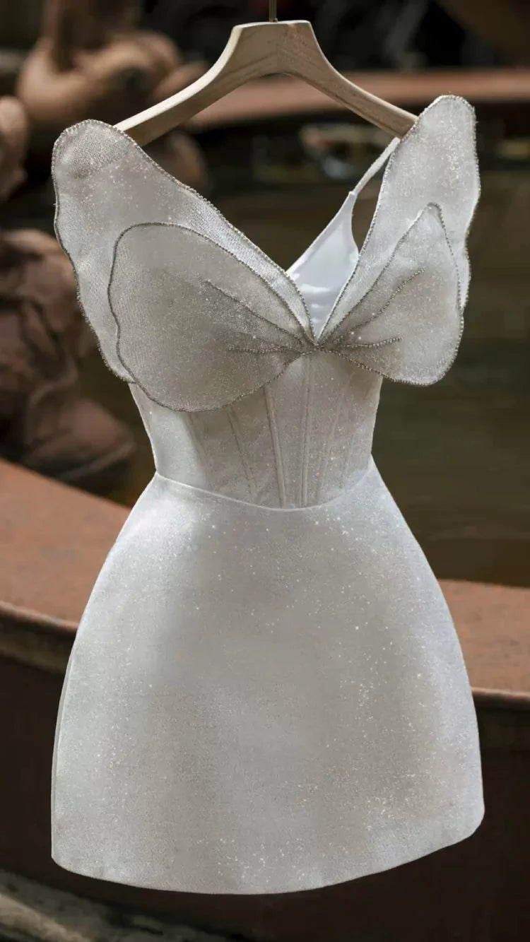 Model wearing an elegant light blue strapless A-line short prom dress.