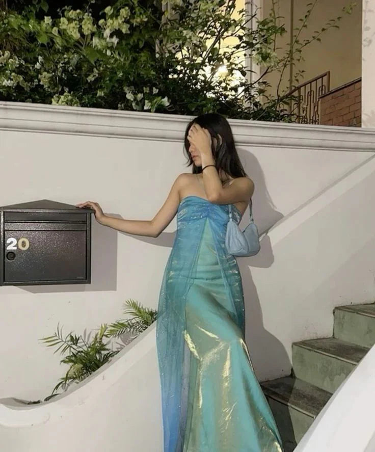 Woman in a long strapless camisole evening gown with pearl embellishments.