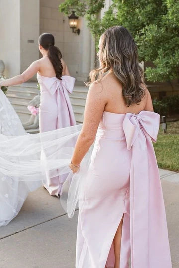 Back view of the pink strapless satin bridesmaid dress, highlighting the large decorative bow.