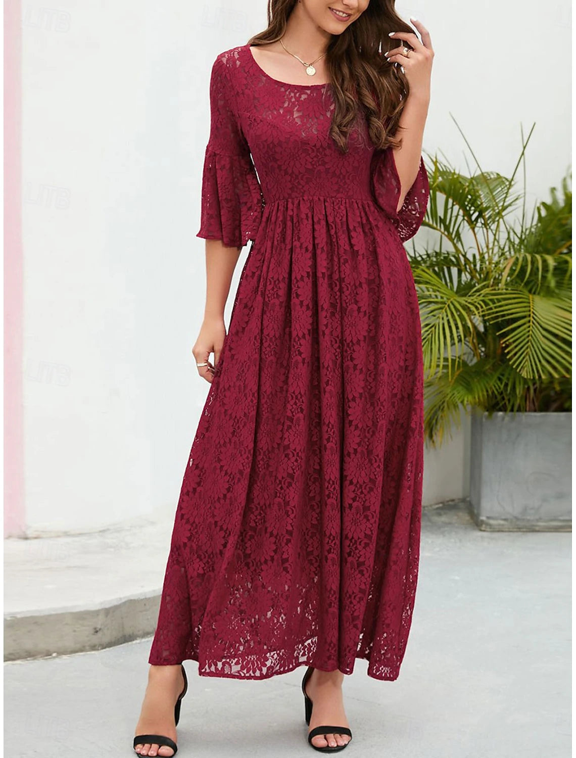 Elegant A-line lace dress with short flared sleeves and crew neck.