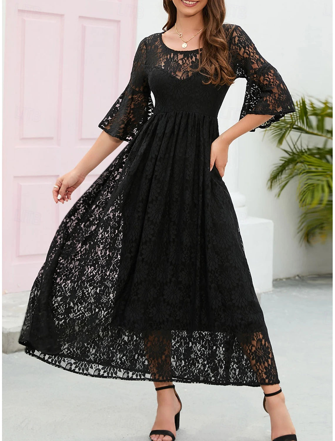 Close-up of the delicate lace fabric and flared sleeve detail.