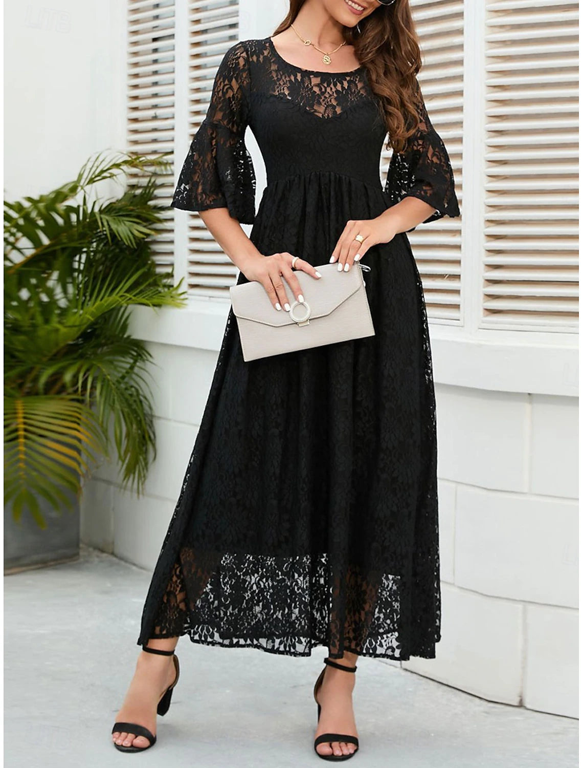 Model posing in the A-line lace dress, suitable for parties.