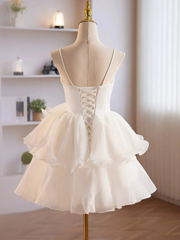 Back view of a model in a white short homecoming dress with a sweetheart neckline.