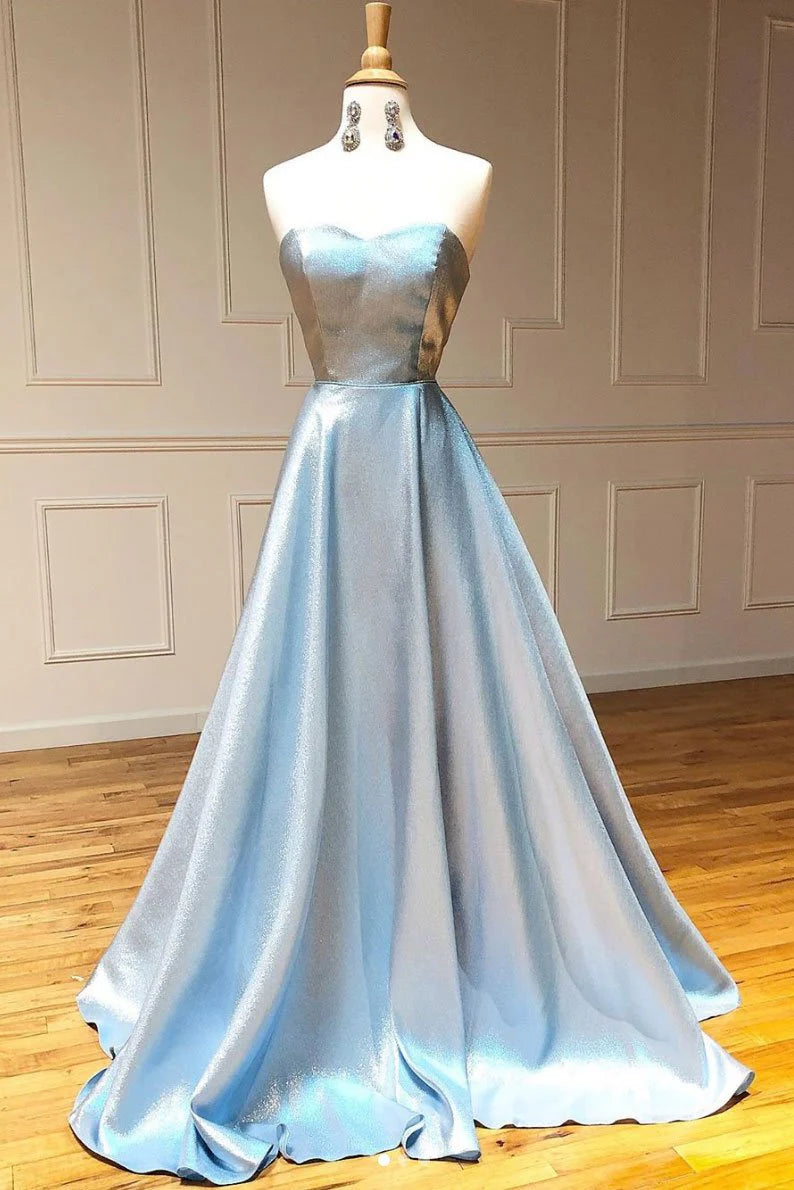 Woman wearing a blue sweetheart off-shoulder long prom dress, front view.