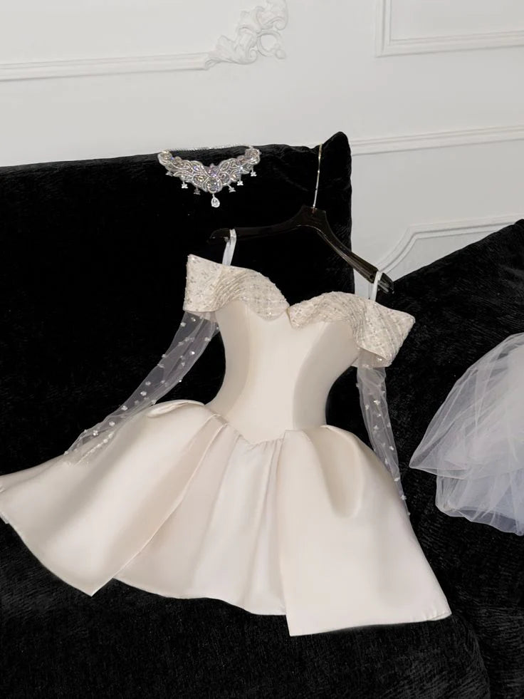 Side view of a woman in an off-shoulder lace and satin short homecoming dress.