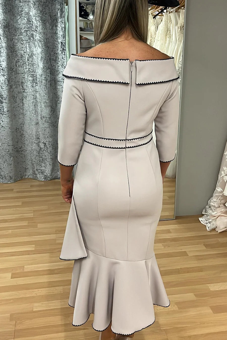 Full-length view of the taupe mother of the bride dress, highlighting the bow-front detail and 3/4 sleeves.