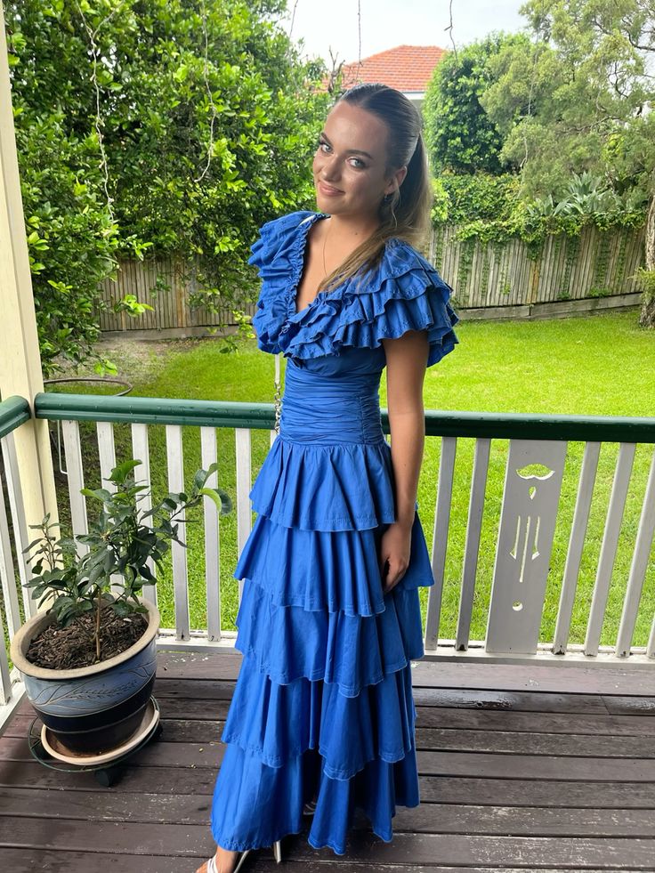 Front view of the blue V-neck tiered formal dress.