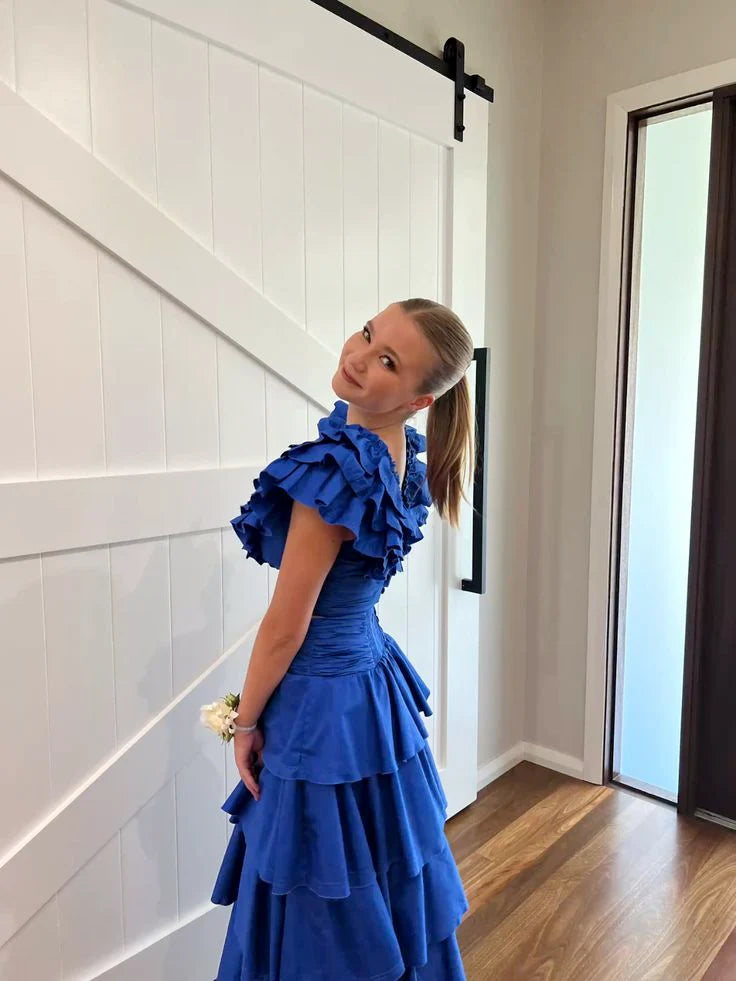 Close-up of the tiered skirt and V-neckline on the blue evening gown.