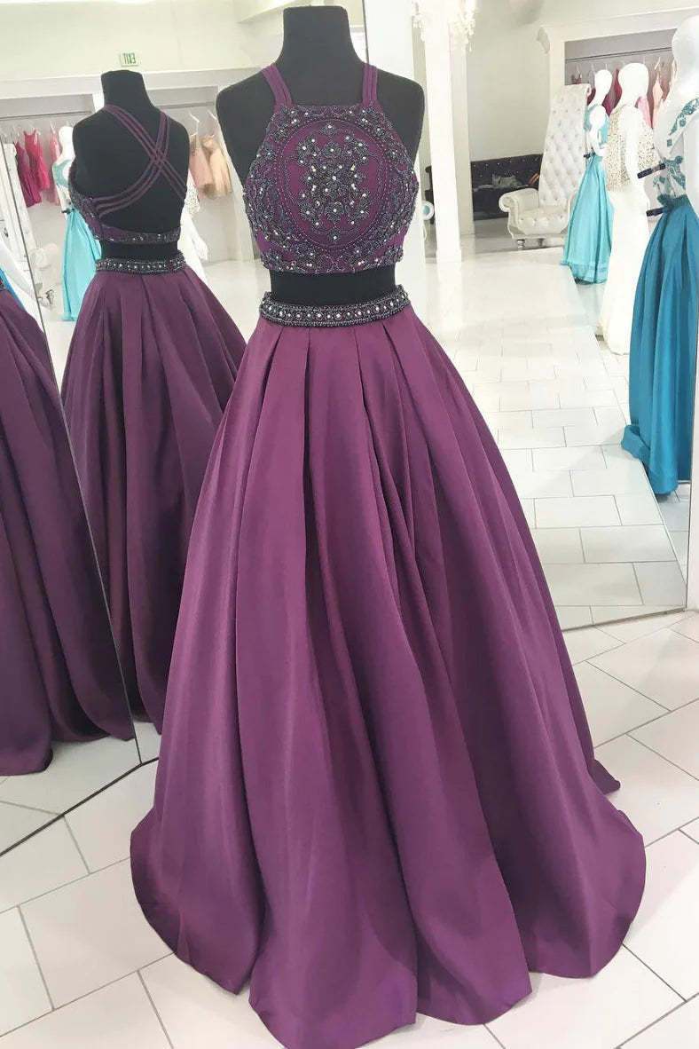 Elegant two-piece beaded high-neck long prom dress in light blue, worn by a woman.
