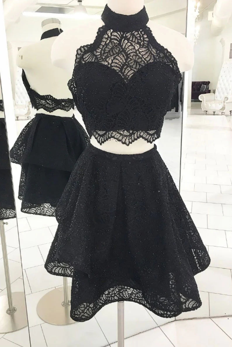 Model wearing an elegant two-piece black lace short prom and homecoming dress with a high neck.