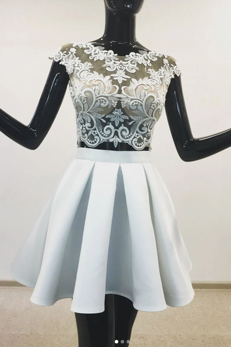 Model wearing a light blue two-piece lace short prom dress, front view.