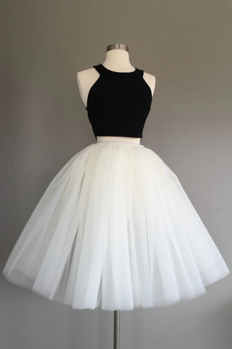 Model wearing a two-piece short tulle prom dress with a sweetheart neckline.