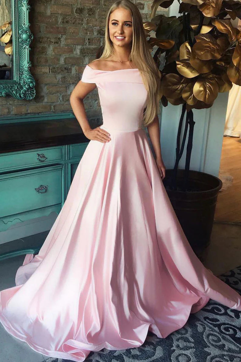 Woman wearing an elegant pink satin V-neck A-line long prom dress.