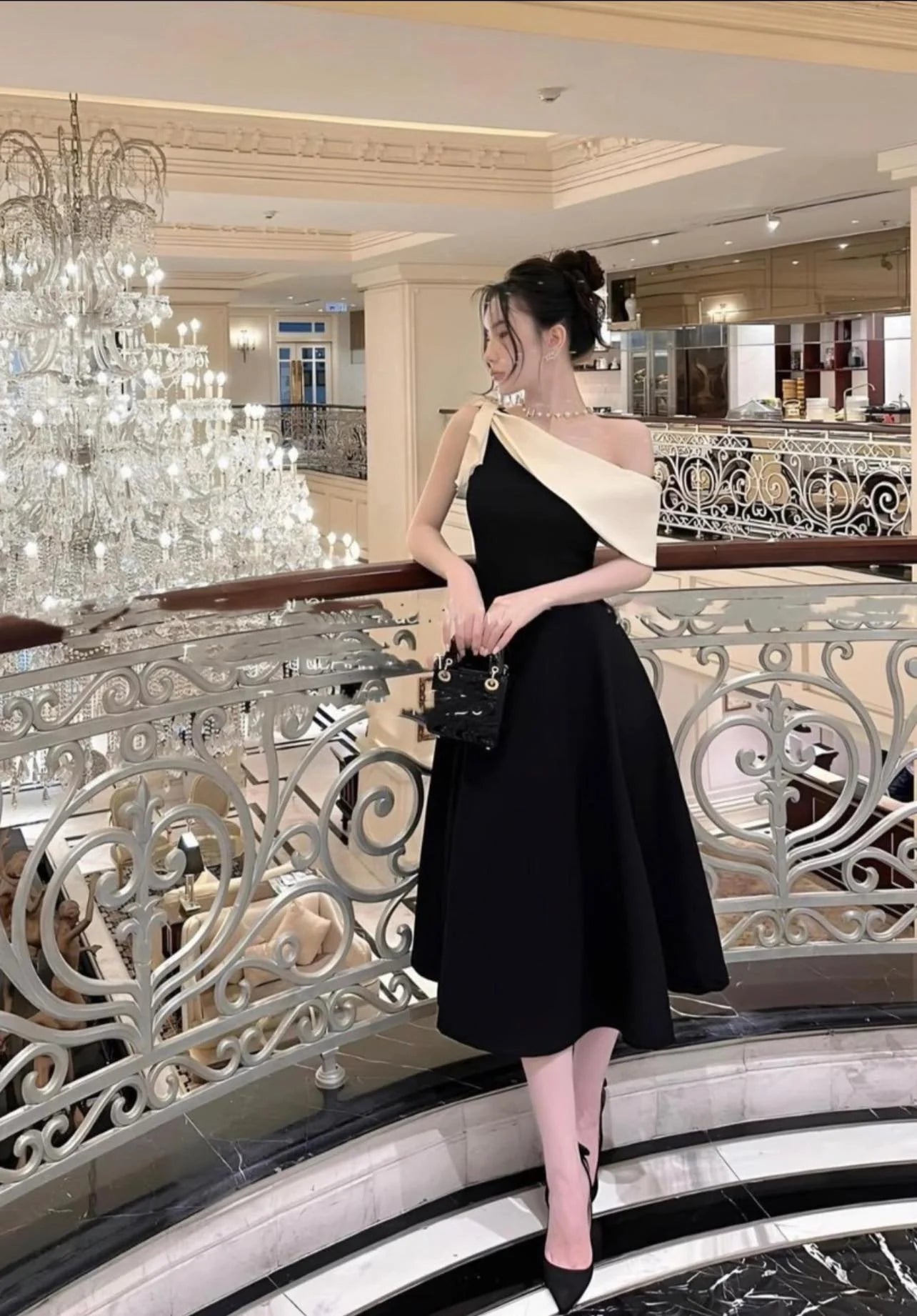 Woman wearing an elegant navy V-neck A-line long evening dress.