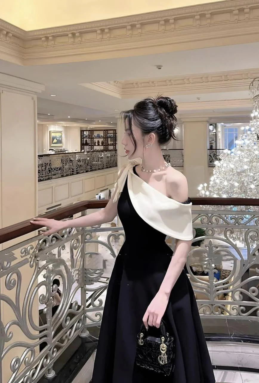 Close-up of the V-neckline and fitted waist of the navy evening dress.