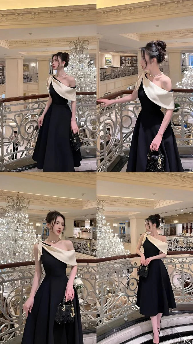 Back view of a woman in the elegant navy long evening dress.