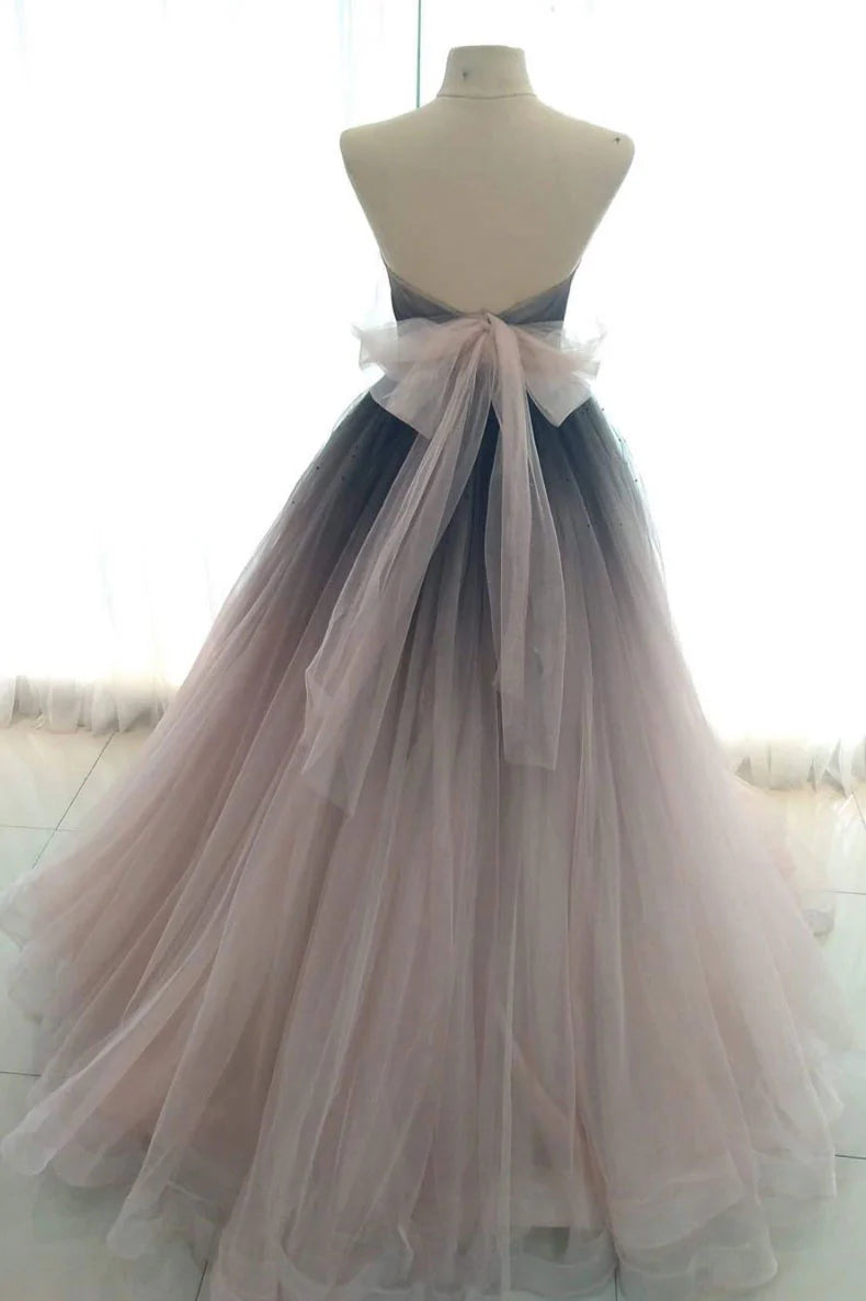 Full view of a flowy V-neck A-line tulle long formal dress.