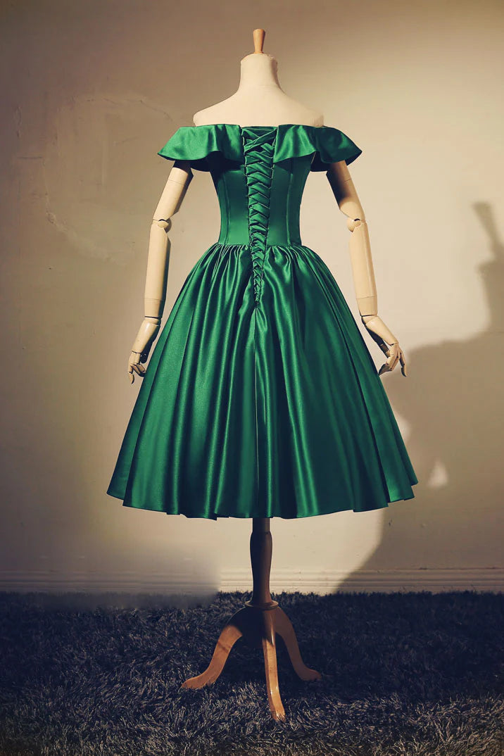 Back view of a green short evening dress, showing the waist-cinching detail.